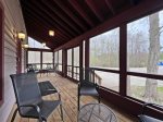 A wonderful screen porch with outdoor furniture welcoming you in 